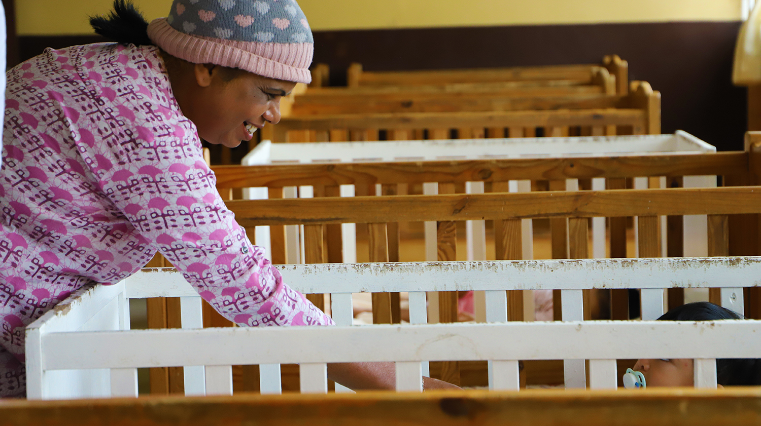 The MFPWA Executive Director Ms. Vidya Charan enjoys a moment with one of the babies at the daycare center