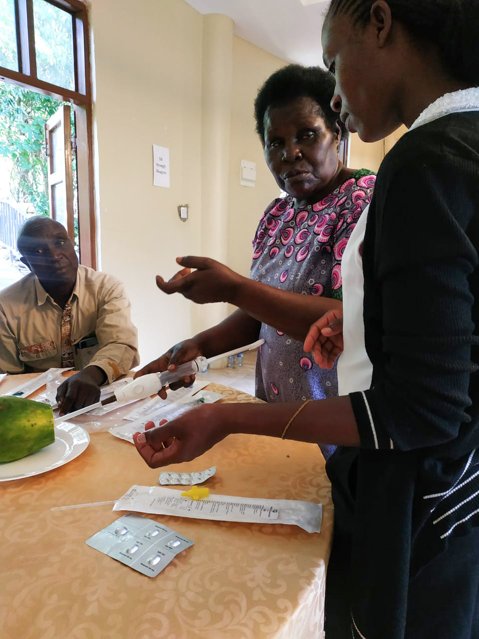 Bevelyn Juma, demonstrating how to use the MVA kit.