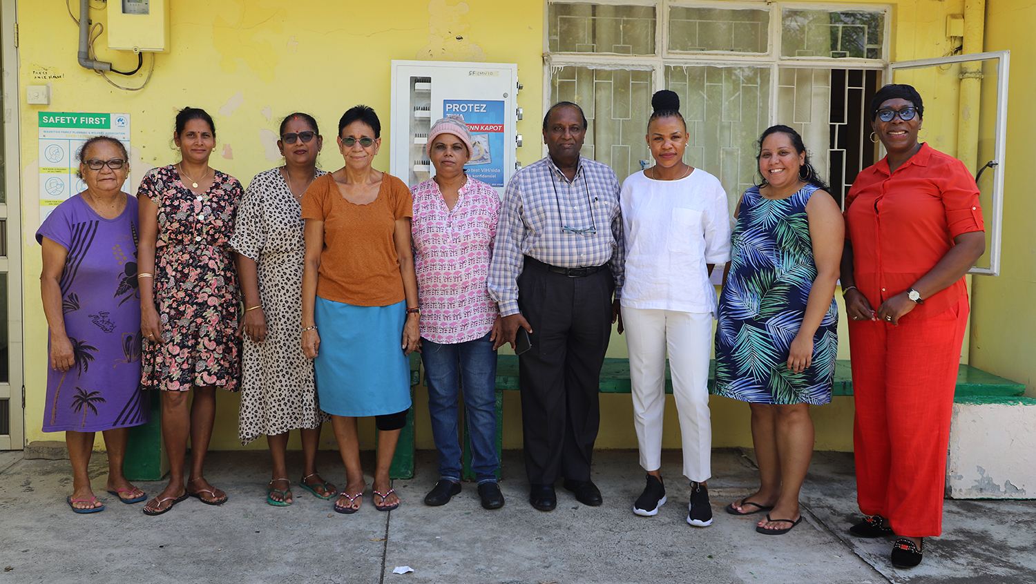 Staff at The MFPWA La Tour Koenig daycare pose for a photo. With them are the MFPWA Executive Director Ms. Vidya Charan, the MFPWA Board Chair Mr. Om Kumar Dabidin and a support team from the IPPF Africa Regional Office that include Ms. Mallah Tabot and Ms. Juliet Sab.