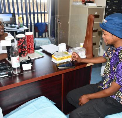 Nurse Mabohlokoa Monyane (L) with male young client Thabile Janele (R)